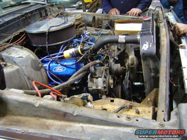 Engine bay with blue Ford valve covers and large air filter