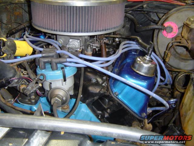 Engine bay with blue valve covers, large air filter, and distributor