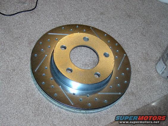 drilled and slotted brake rotor on carpet