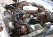 1975 Ford F-150 - The engine bay of a vehicle shows a V8 engine with various components and signs of wear.