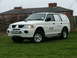 2006 Mitsubishi L200 - White panel van with BT branding is seen from a three-quarter front angle.