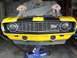 1970 Chevrolet Camaro - A yellow 1970 Chevrolet Camaro Z28 is shown from the front, lifted on a jack.