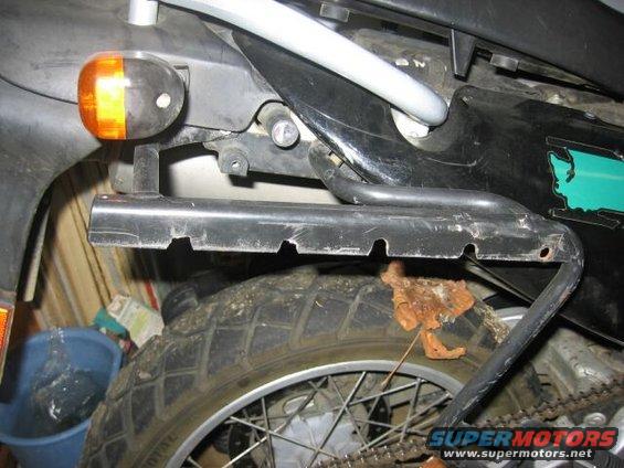 motorcycle rear fender, turn signal, and wheel with chain visible