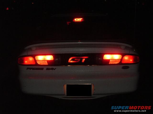 White 1996 Ford Probe GT rear with illuminated taillights and GT badge