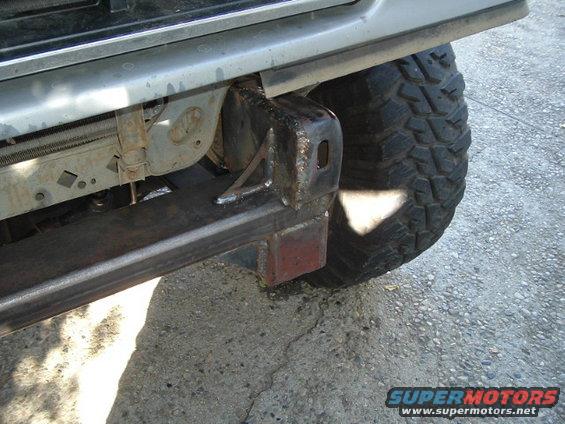 Custom front bumper and large off-road tire on a vehicle
