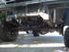 1984 Ford Bronco - Undercarriage view of a lifted truck's front suspension and drivetrain components.
