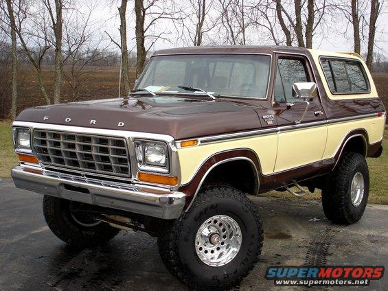 Brown and tan Ford Bronco with chrome grille and aftermarket wheels