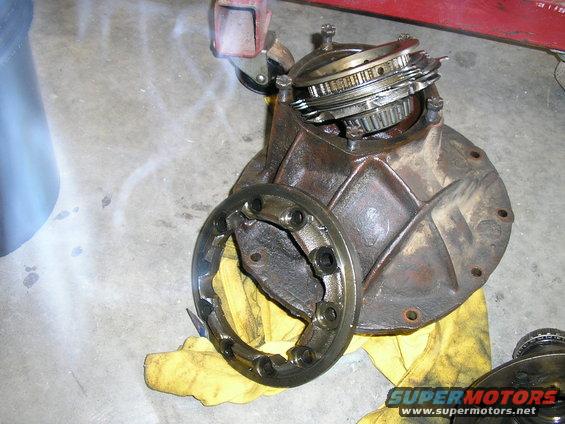Differential housing with gears and bearing retainer removed, resting on a yellow cloth