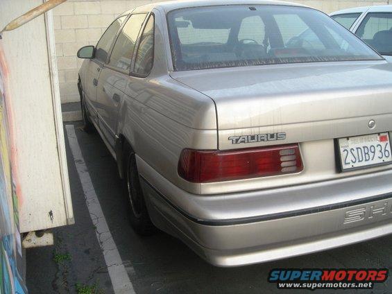Silver 1991 Ford Taurus sedan parked, rear view, California license plate 2SDB936