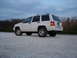1997 Jeep Grand Cherokee - White 1997 Jeep Grand Cherokee parked on gravel under a cloudy sky.