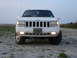 1997 Jeep Grand Cherokee - Front view of a white 1997 Jeep Grand Cherokee parked outdoors.