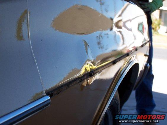 100_0390.jpg Second shot of dent with trim removed.  75% of dent hammered out.