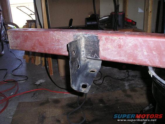 Red metal bumper section with a black metal bracket attached