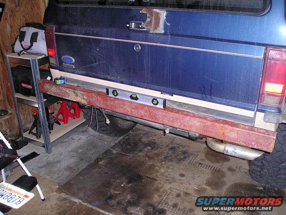 1986 Ford Bronco II rear bumper installation with a level and jack stands