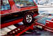 1989 Chevrolet S10 - This red and black 1989 Chevrolet S10 Blazer is captured from the rear as it is loaded onto a trailer.
