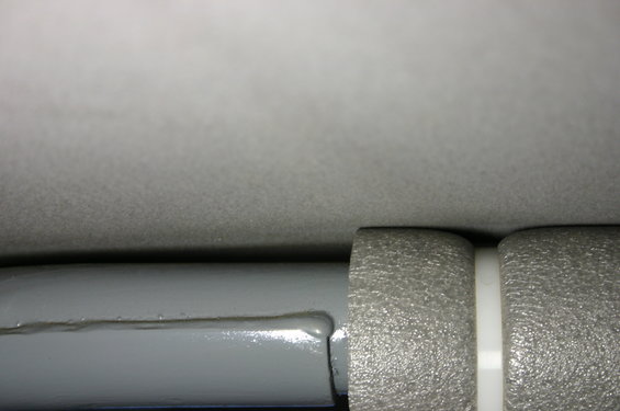 Gray roll bar with textured gray padding and a white plastic spacer