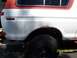 1978 Ford Bronco - The rear quarter panel of a 1978 Ford Bronco shows significant rust damage around the wheel well.