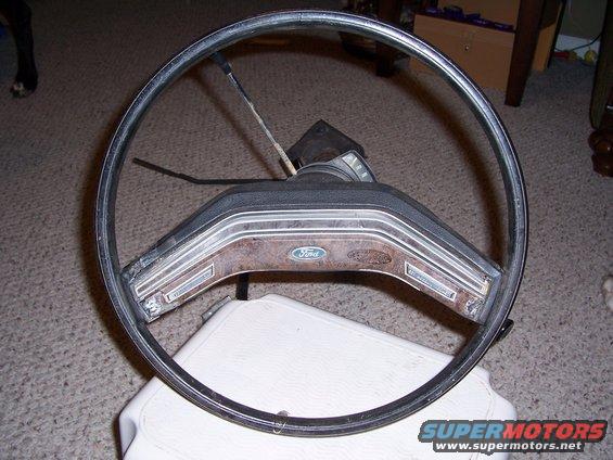Ford steering wheel with wood grain trim and Ford logo