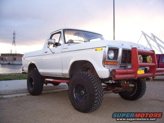 White 1978 Ford Bronco with red bull bar and KC lights