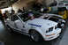 2005 Ford Mustang - A race car is parked in a garage, with another race car visible in the background.