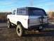 1978 Ford Bronco - Rear view of a silver 1978 Ford Bronco with a black hardtop and custom rear bumper.