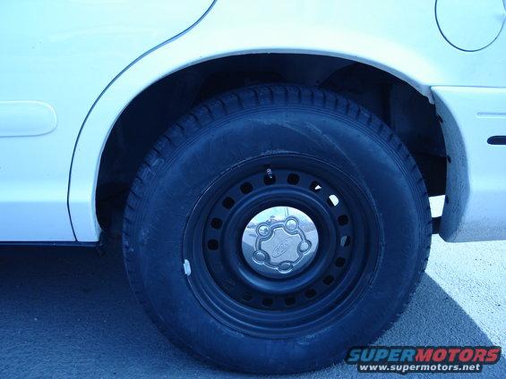 2000 Ford Crown Victoria rear wheel and tire with steel rim and hubcap