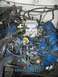 1979 Ford Bronco - Close-up view of a vehicle's engine compartment, focusing on the carburetor and associated wiring.