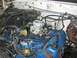 1979 Ford Bronco - The engine bay of a 1979 Ford Bronco, showing the carburetor and associated components.