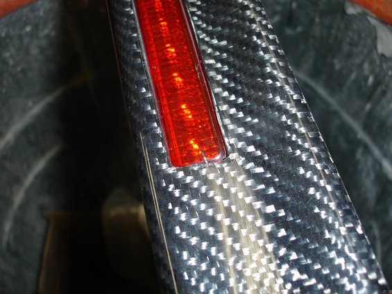 Carbon fiber spoiler with a red reflector light