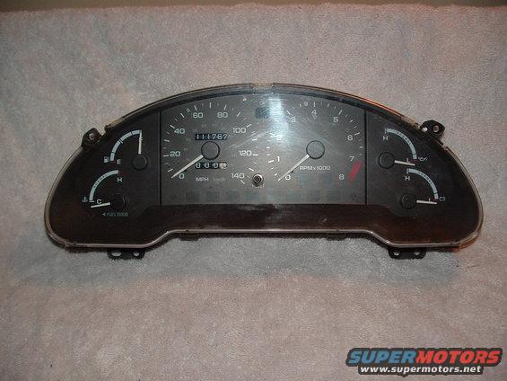 Car dashboard instrument cluster with speedometer, tachometer, fuel gauge, and temperature gauge