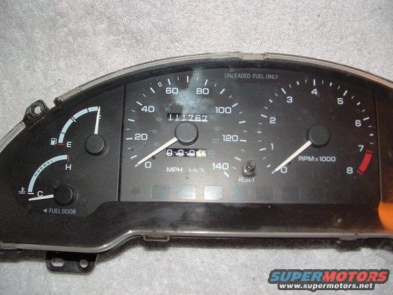 Car gauge cluster with speedometer, tachometer, fuel gauge, and temperature gauge. Odometer shows 111767 miles