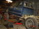 1982 Nissan Titan - Pickup truck chassis undergoing work in a garage, with a jack supporting the frame.