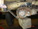 1982 Nissan Titan - Close-up view of a vehicle's transfer case and associated drivetrain components, elevated on wooden blocks.