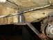 1982 Nissan Titan - Close-up view of a vehicle's undercarriage, highlighting the transmission and frame with a visible weld modification.