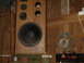 1982 Nissan Titan - A large speaker cabinet is mounted on a wall in what appears to be a workshop or garage.