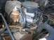 1986 Ford Bronco - Close-up of an engine bay, focusing on the carburetor and associated wiring and hoses.