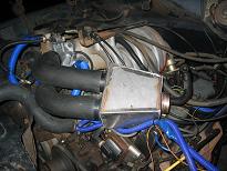 Engine bay with blue hoses and aftermarket intake