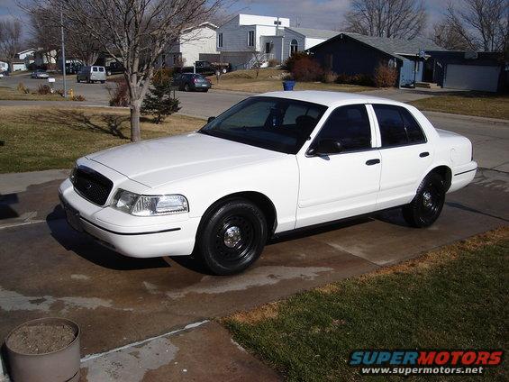 White 2000 Ford Crown Victoria parked on a driveway, front 3/4 view