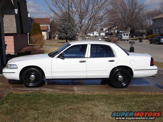 White 2000 Ford Crown Victoria sedan, side view, black wheels