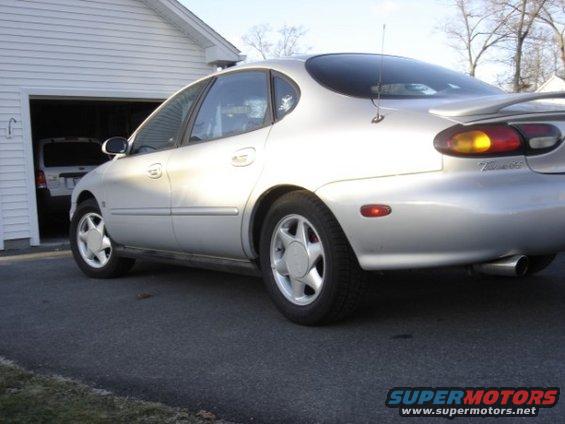 Silver 1999 Ford Taurus rear quarter view, parked in driveway