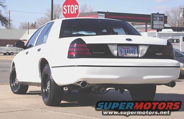White 2000 Ford Crown Victoria rear view with custom wheels and tinted taillights