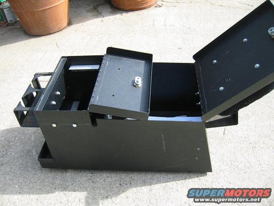 Black metal storage box with open lid and tray, visible Supermotors logo