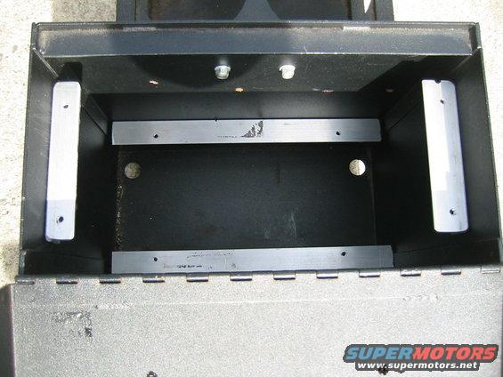 Empty black metal storage box with silver mounting brackets inside