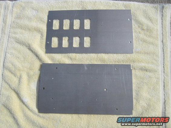 Two metal panels with rectangular cutouts for switches, laid on a towel