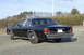 1991 Ford Crown Victoria - Rear view of a black sedan with a license plate reading 26P R35, parked outdoors on a gravel surface.