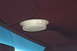1991 Ford Crown Victoria - The interior dome light is visible on the maroon headliner of the vehicle.