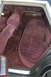 1991 Ford Crown Victoria - The interior of a car shows the rear bench seat and door panel with maroon velour fabric.
