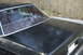 1991 Ford Crown Victoria - The rear of a black 1991 Ford Crown Victoria is visible, showing the trunk and rear window.