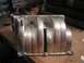 1986 Ford Bronco - An aluminum intake manifold with a ribbed design is shown on a workbench.