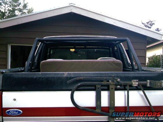 1989 Ford Bronco rear view with aftermarket roll cage and spare tire carrier
